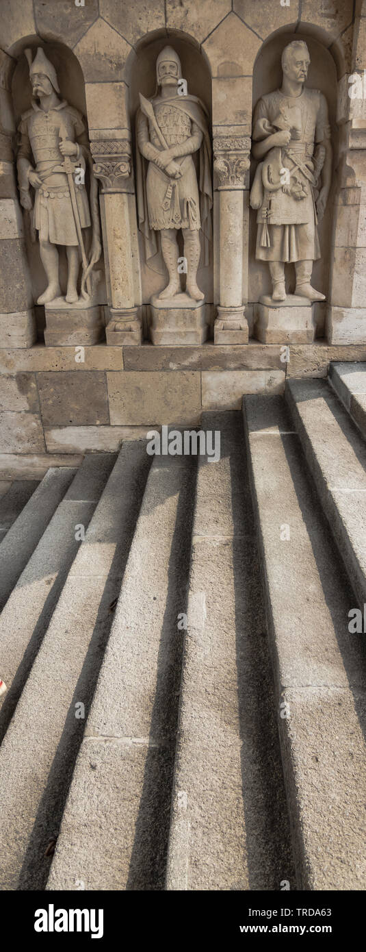 Three stone statues guarding top of stairway to Fisherman`s Bastion, in